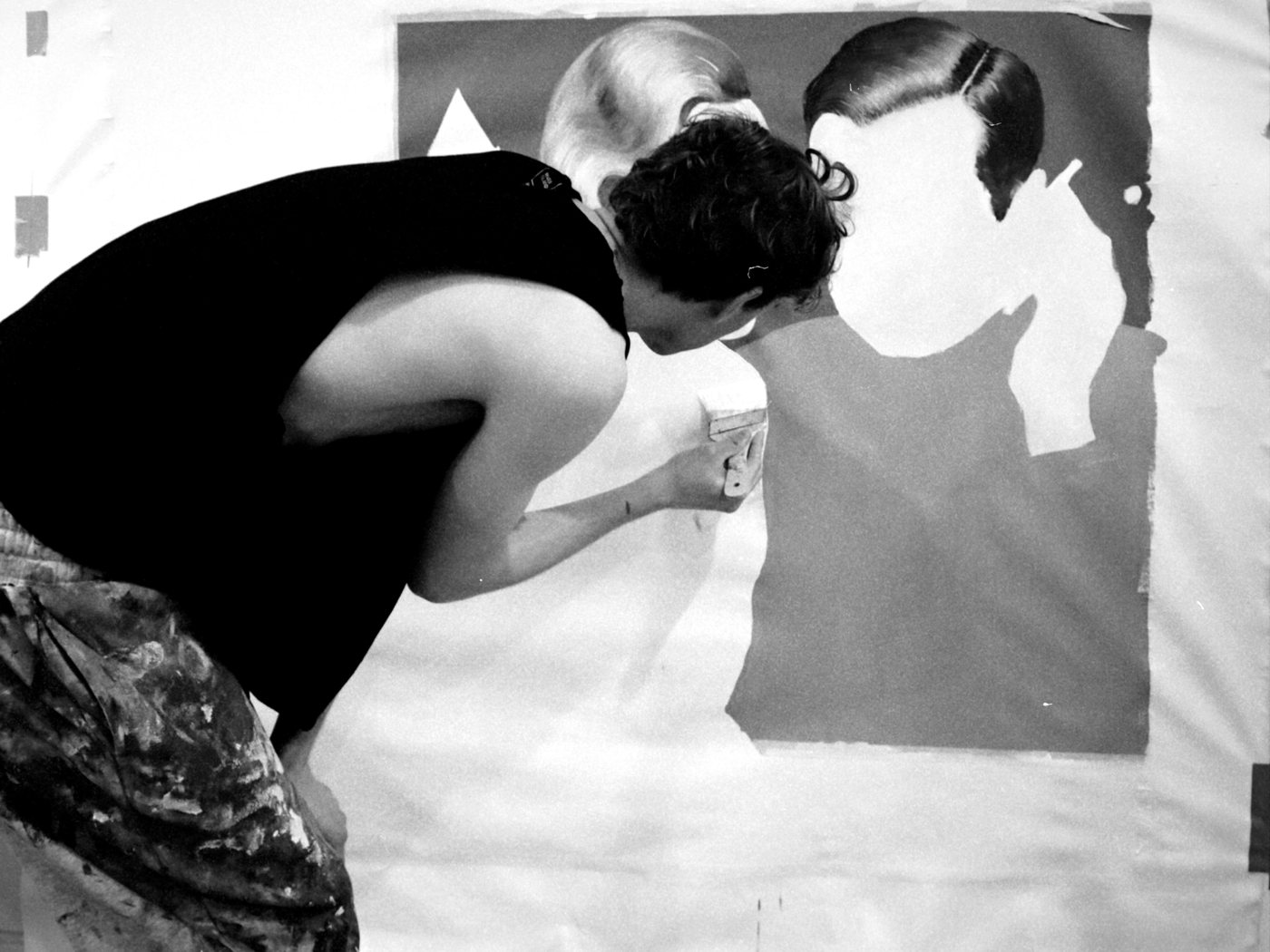 Elijah McKenzie-Jackson bent over the canvas